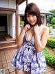 A woman in a blue and white dress posing for a picture.