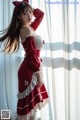 a woman in a red and white dress posing for a picture